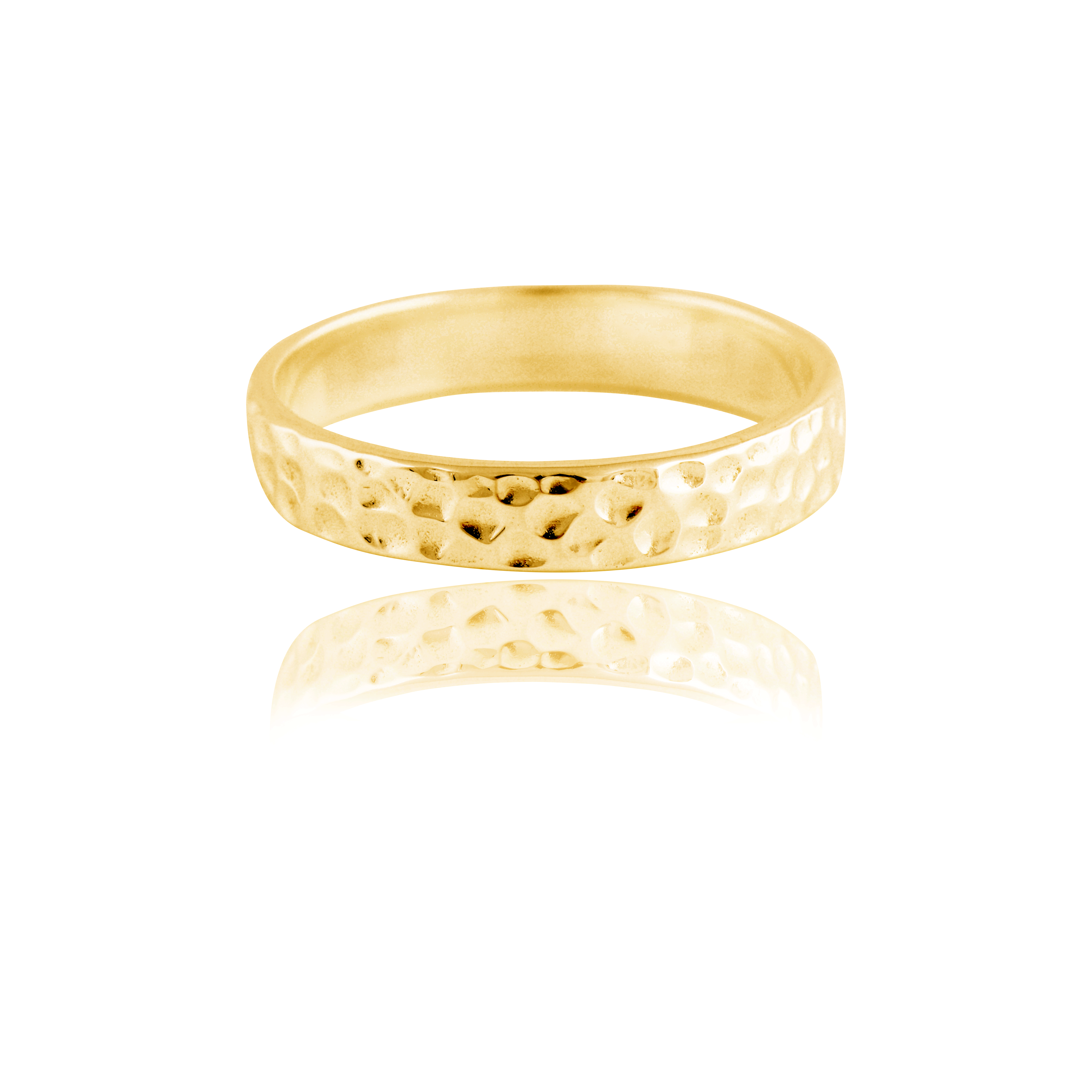 A thin gold hammered ring isolated on a white background with a reflection.