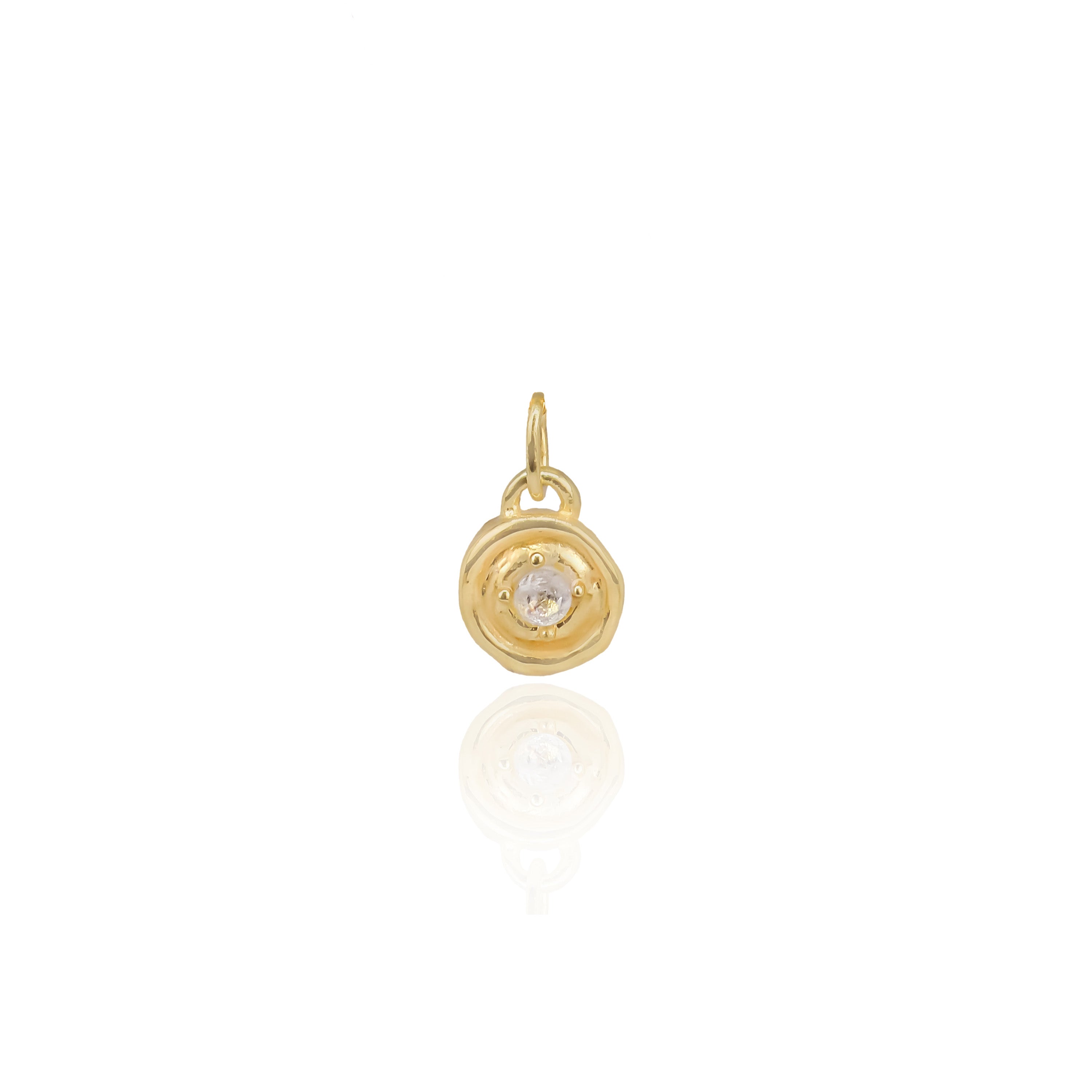 Gold pendant with a central gemstone on a white background