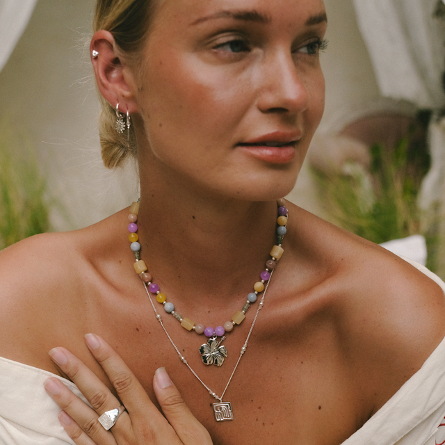 Bright daylight highlighting silver jewelry on a woman