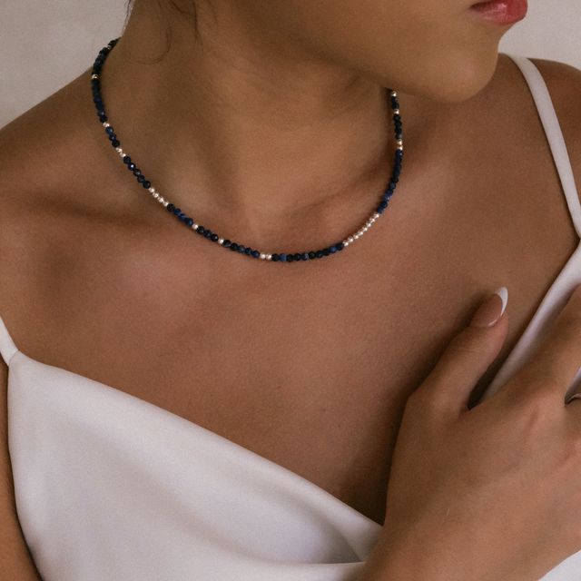 Fashion portrait of a woman wearing a silver necklace