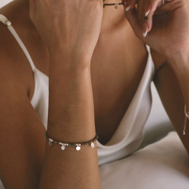 Fashionable accessory: bracelet with beads and a small droplet charm