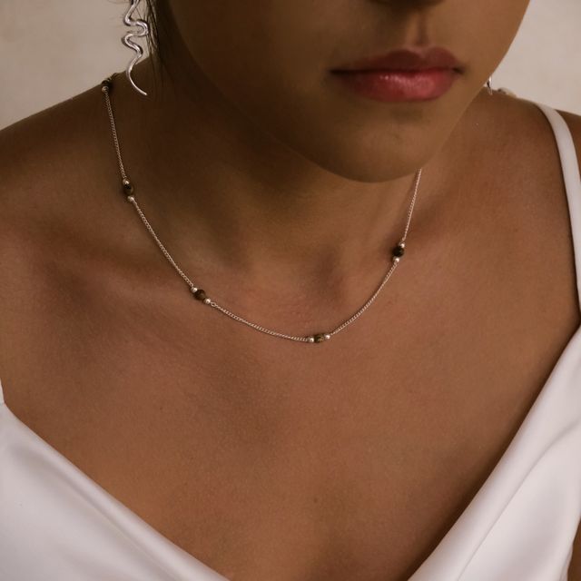 Fashionable woman showcasing multiple silver jewelry accessories