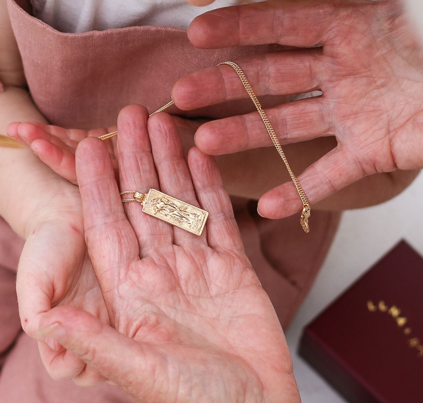 a woman holding Freyja Goddess of Love Pendant gold