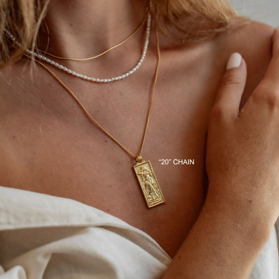 Gold necklace with a pendant worn by a person, with '20" Chain' text overlay.