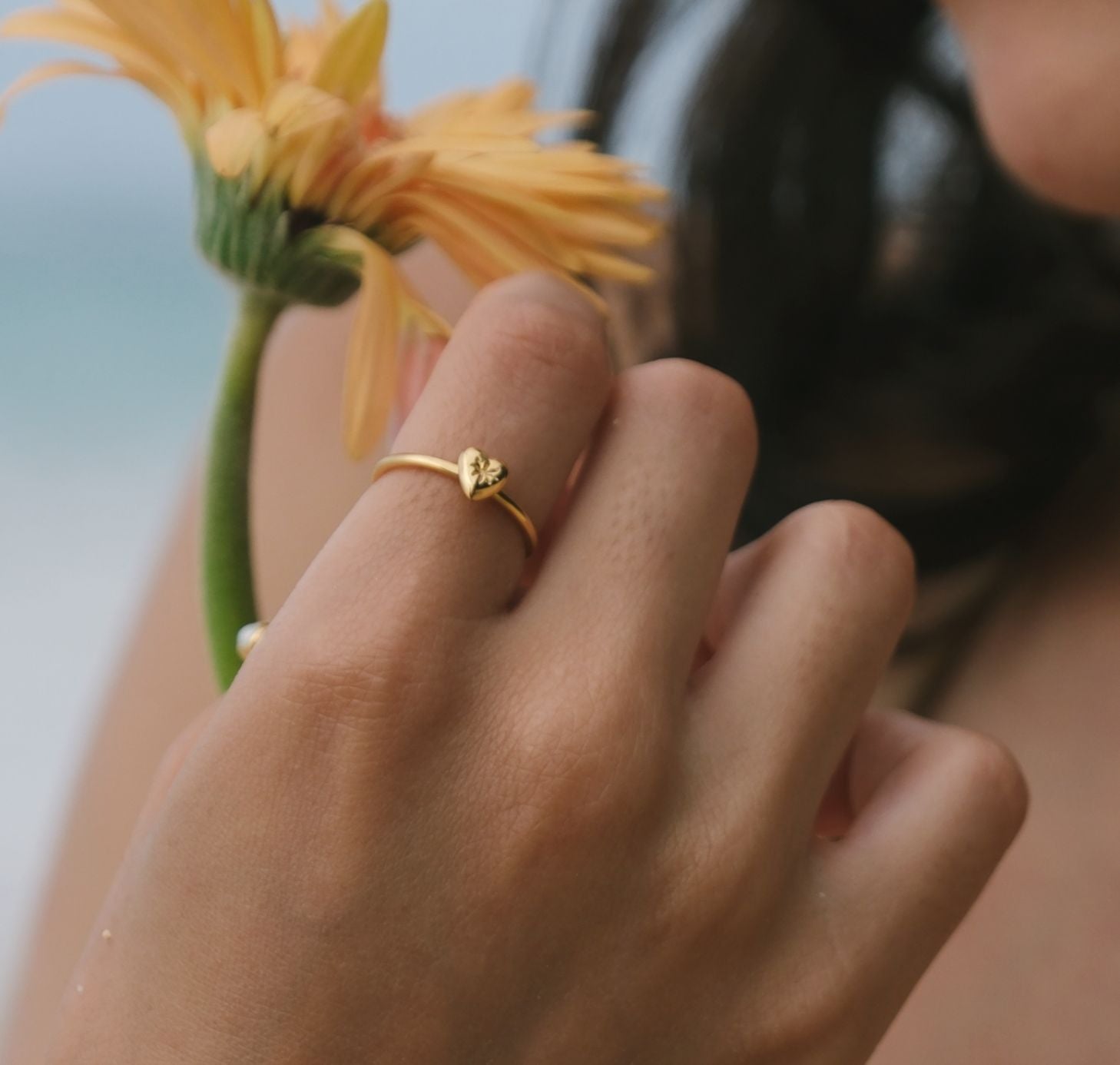 Gold mini heart ring on Finger