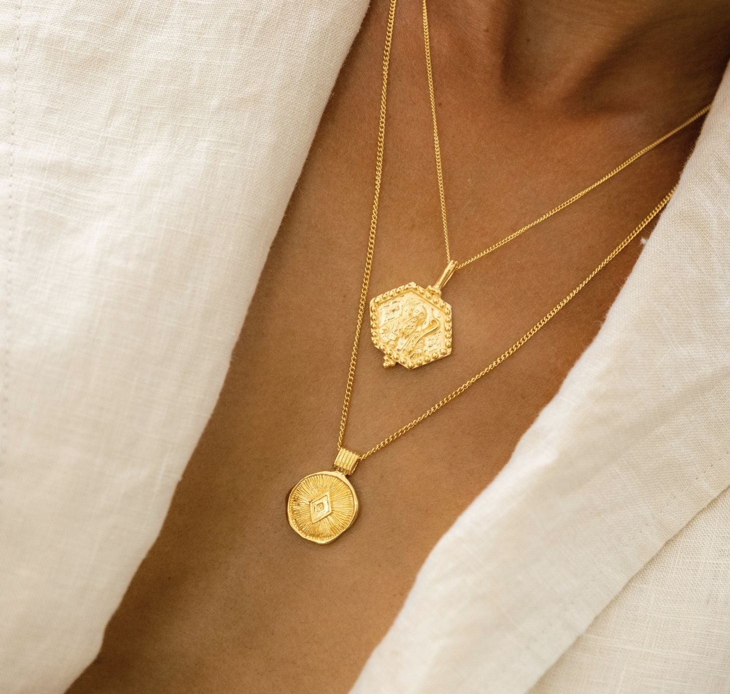 Health pendant in gold and St Benedict on a woman with white collar