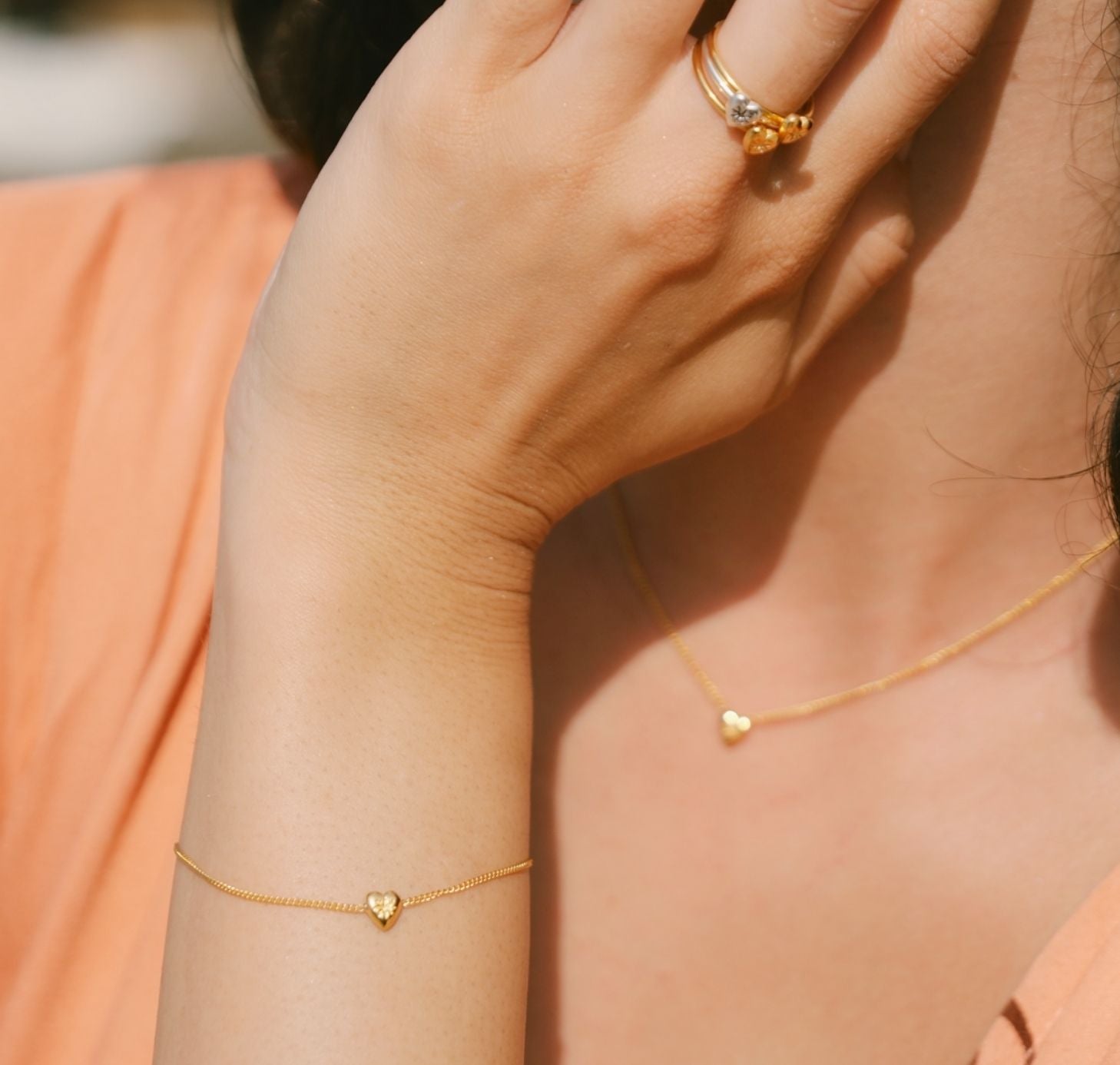 Girl wearing Heart bracelet and matching rings and matching heart necklace