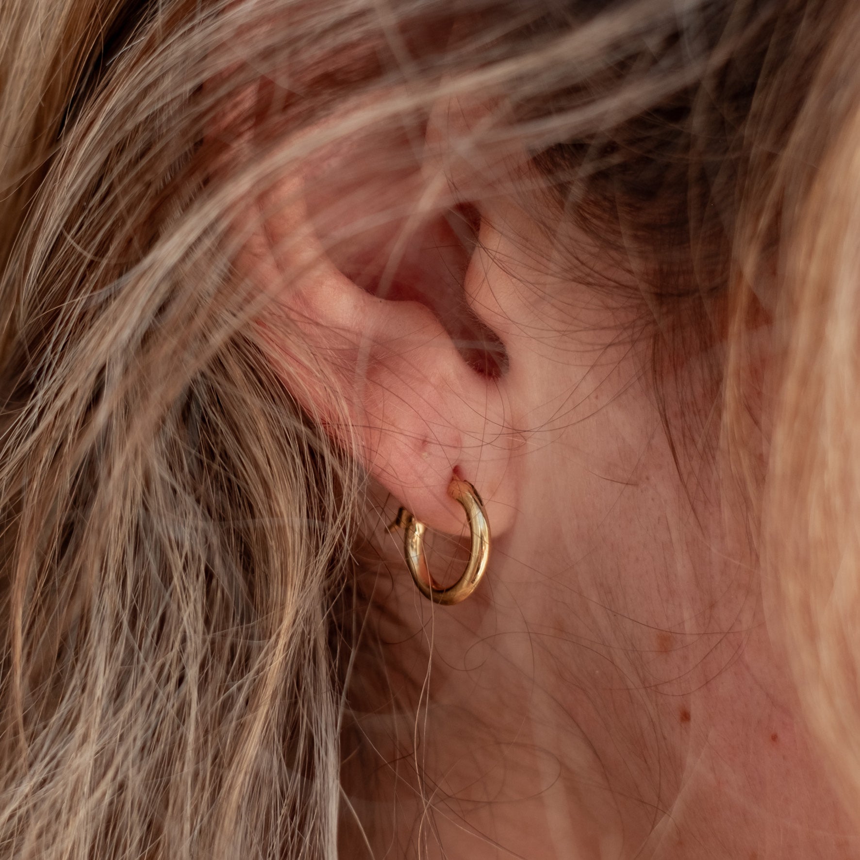Signature Hoops 10mm Petite - Gold on a woman with blonde hair