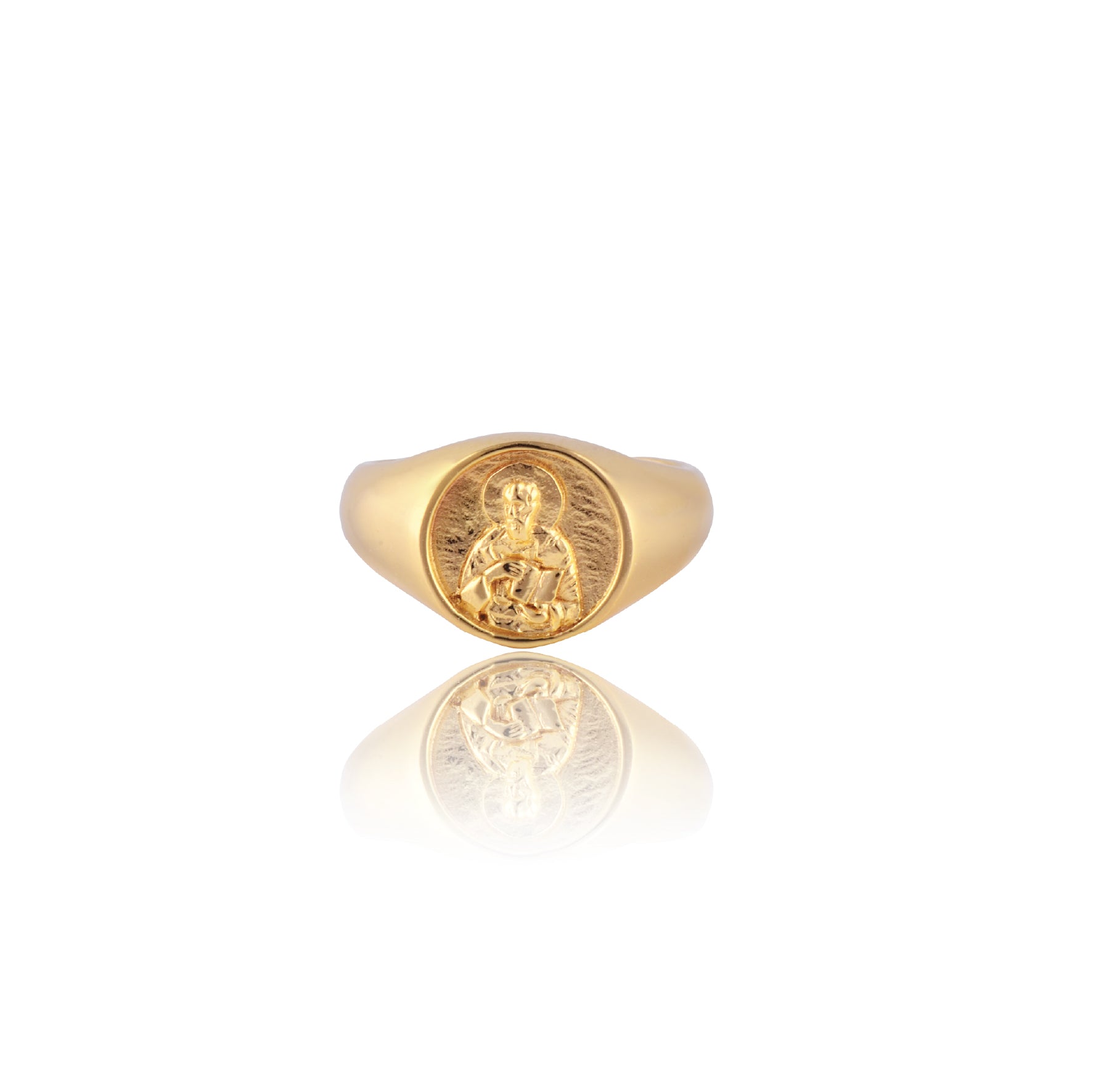 A gold signet ring featuring an intricately detailed depiction of a saint figure holding a book on its face.