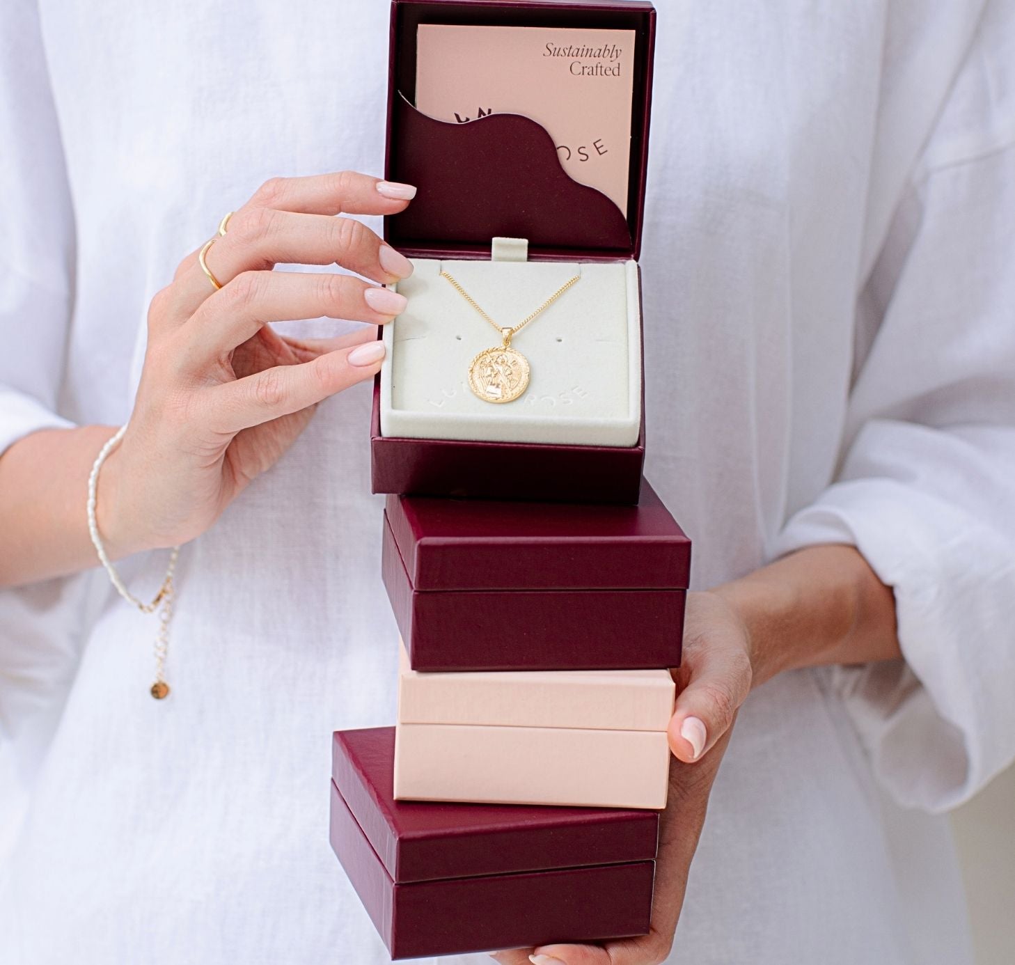 a woman holding Luna and Rose jewelry boxes