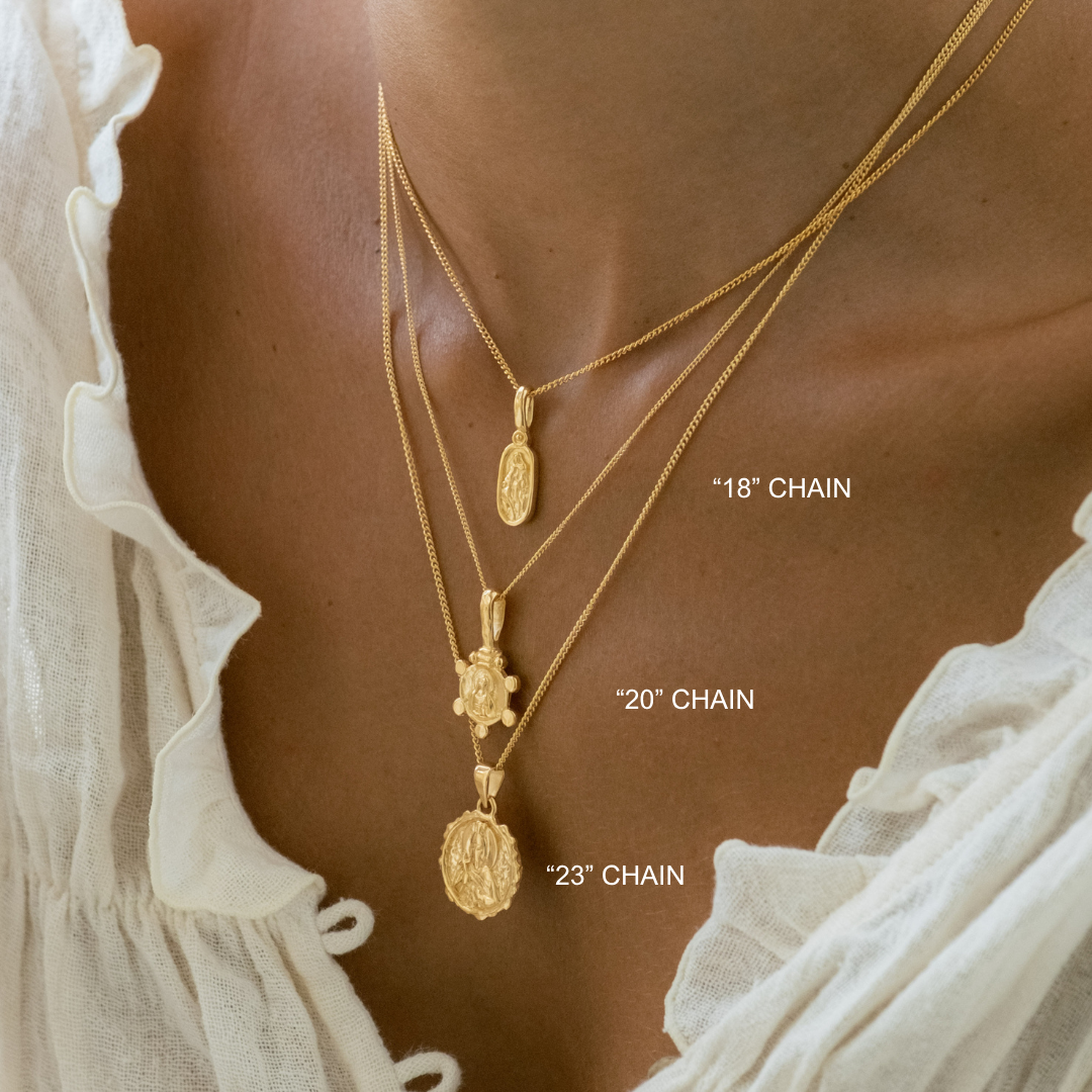 Gold necklaces with chain lengths labeled on a person wearing a white blouse.