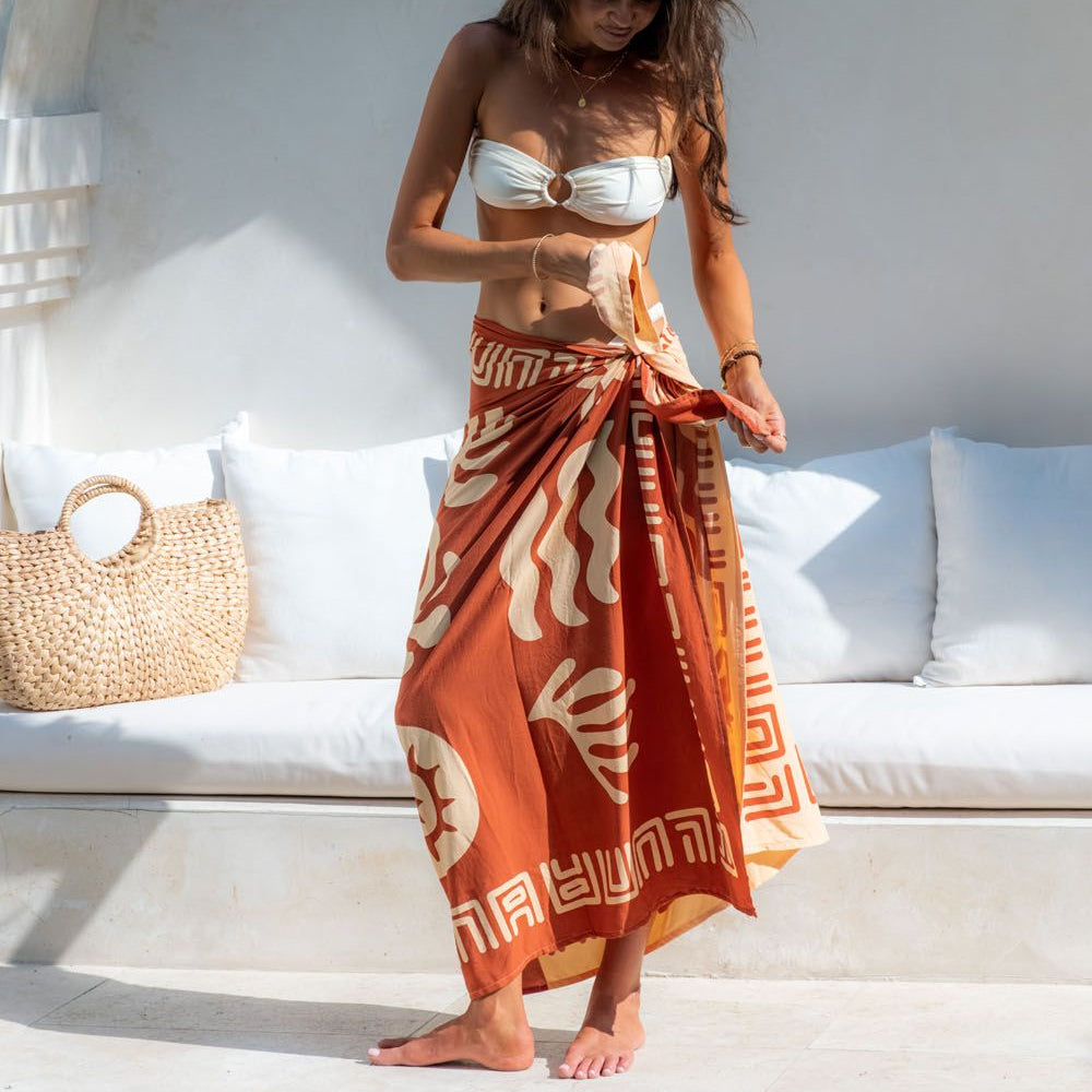 Woman wearing a terracotta sarong in a relaxed setting