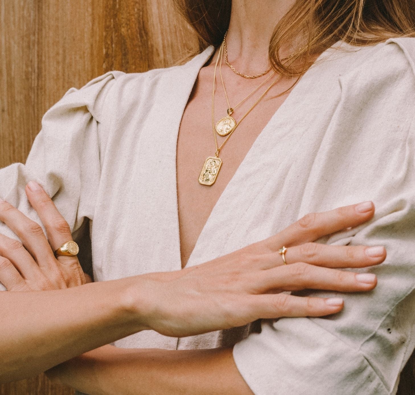 a woman wearing jewelry gold necklaces and rings