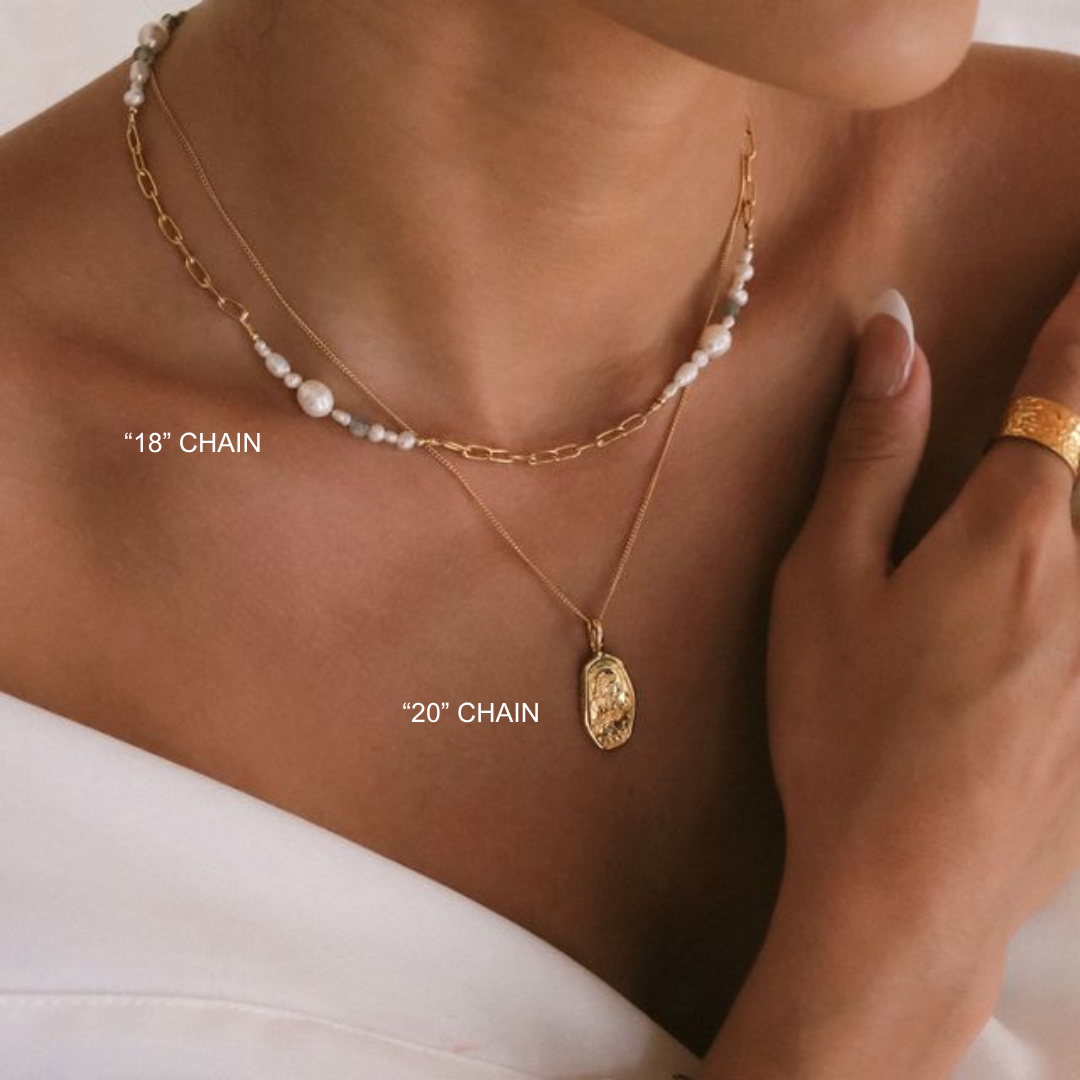 Gold necklaces with chain lengths labeled on a person wearing a white garment.