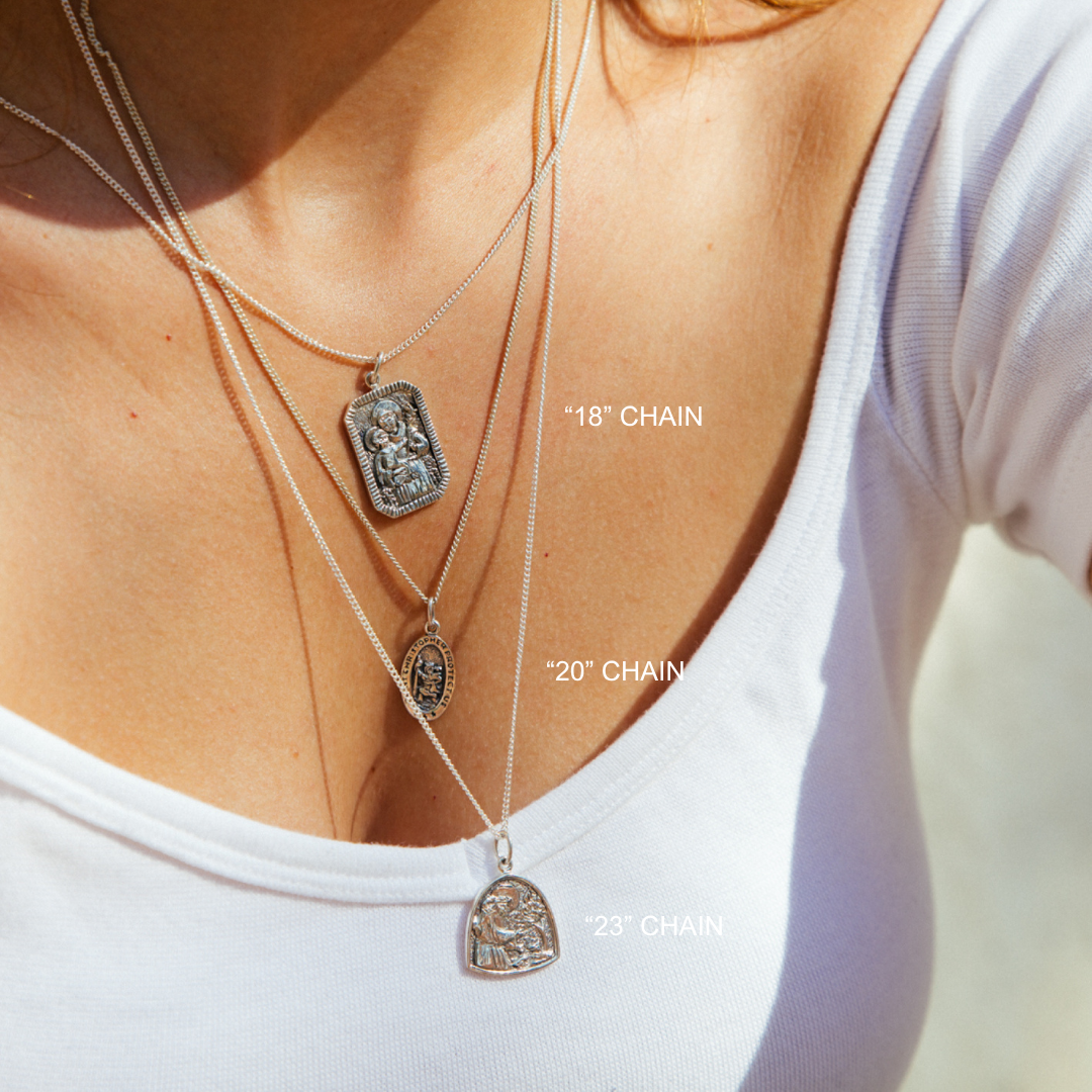 Close-up of layered necklaces with chain lengths labeled on a white background