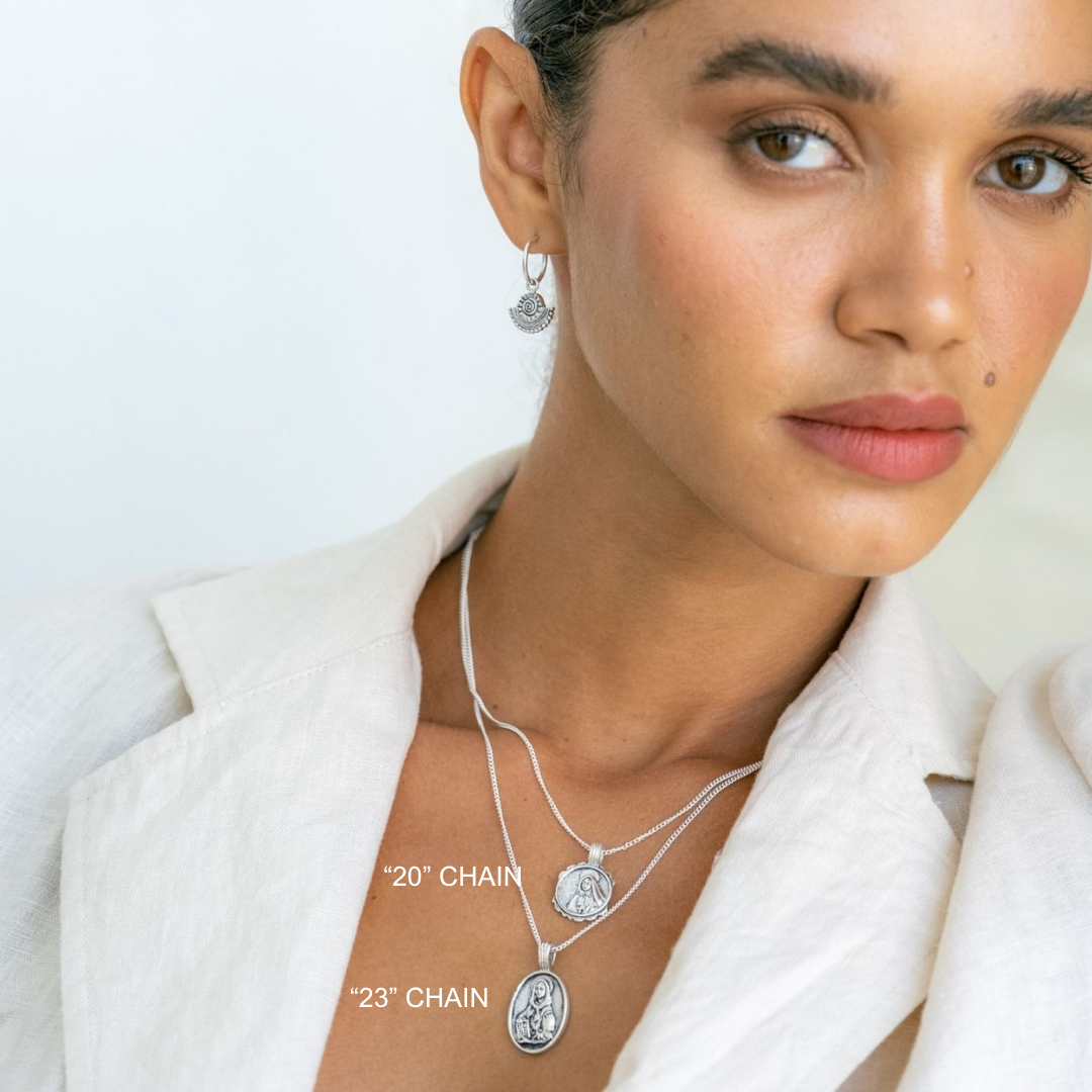 Woman wearing silver necklaces with chain lengths labeled on a light background