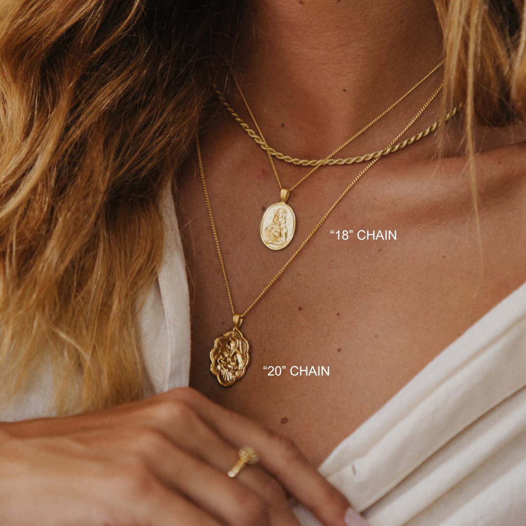 Close-up of a person wearing two gold necklaces with chain lengths labeled.