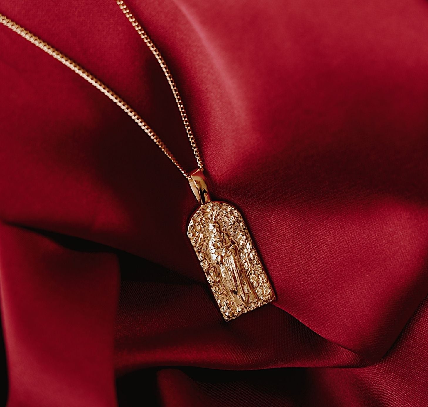 St Fiacre - Patron Saint of Gardening - CHARM ONLY - Gold flat lay in red fabric