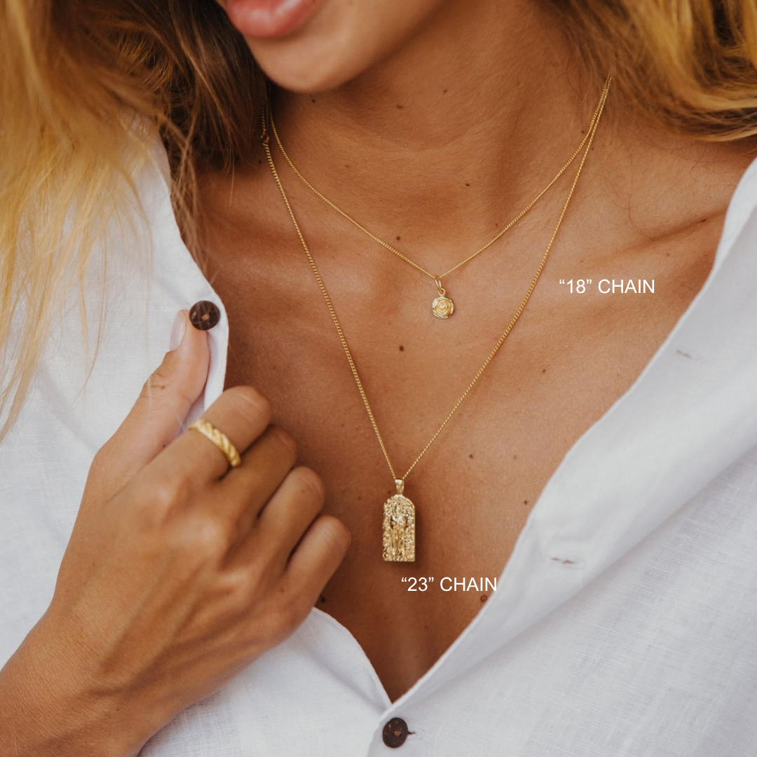 Close-up of a person wearing two gold necklaces with labeled chain lengths on a white background.