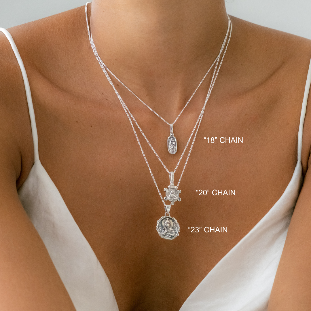 Necklaces with chain lengths labeled on a person wearing a white top.