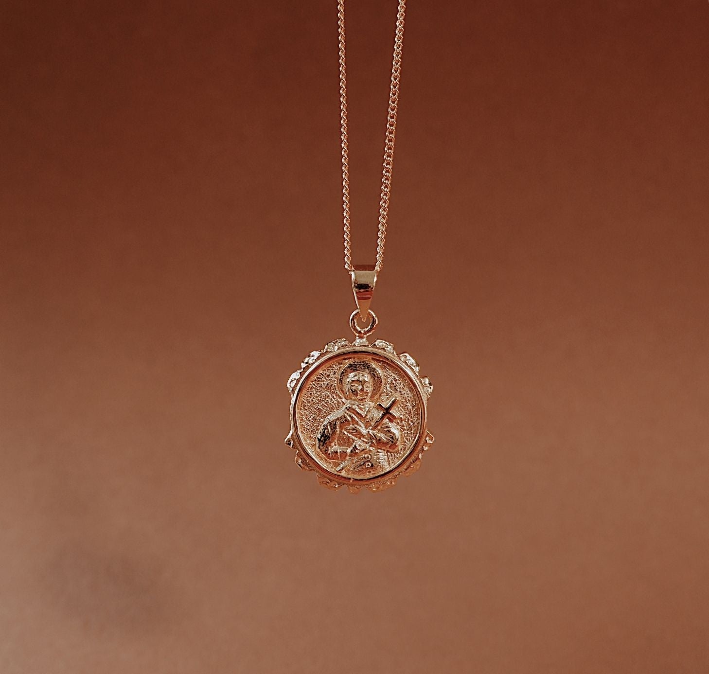 St Gerard pendant gold in red background