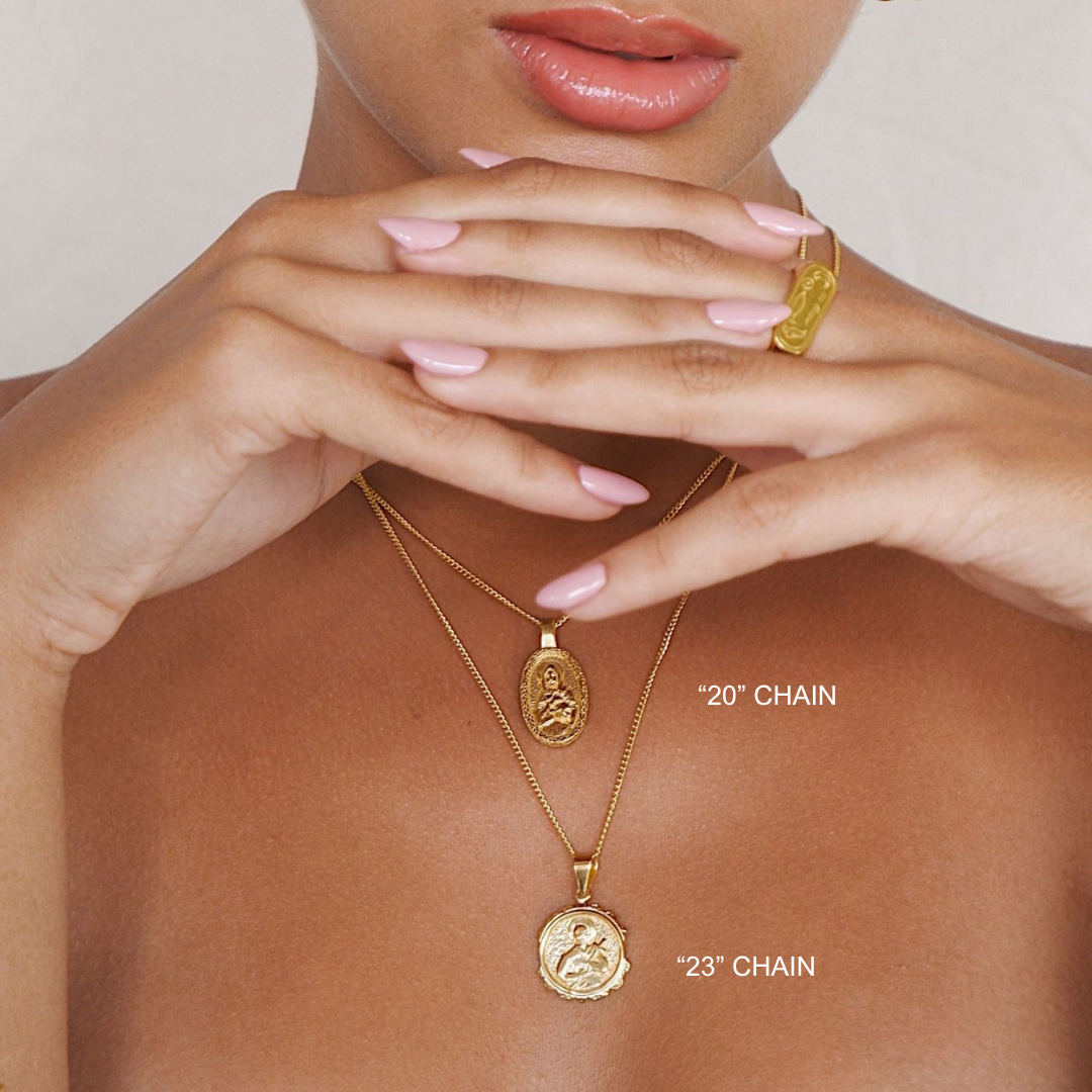Gold necklaces with pendants on a model's neck and chest, showing chain lengths.