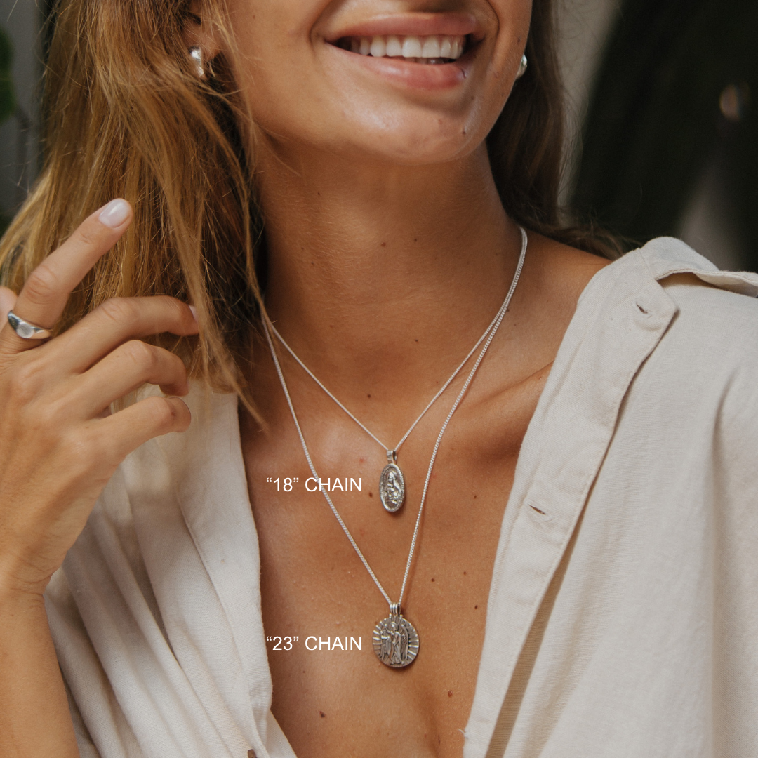 Woman wearing layered necklaces with chain lengths labeled, against a neutral background.