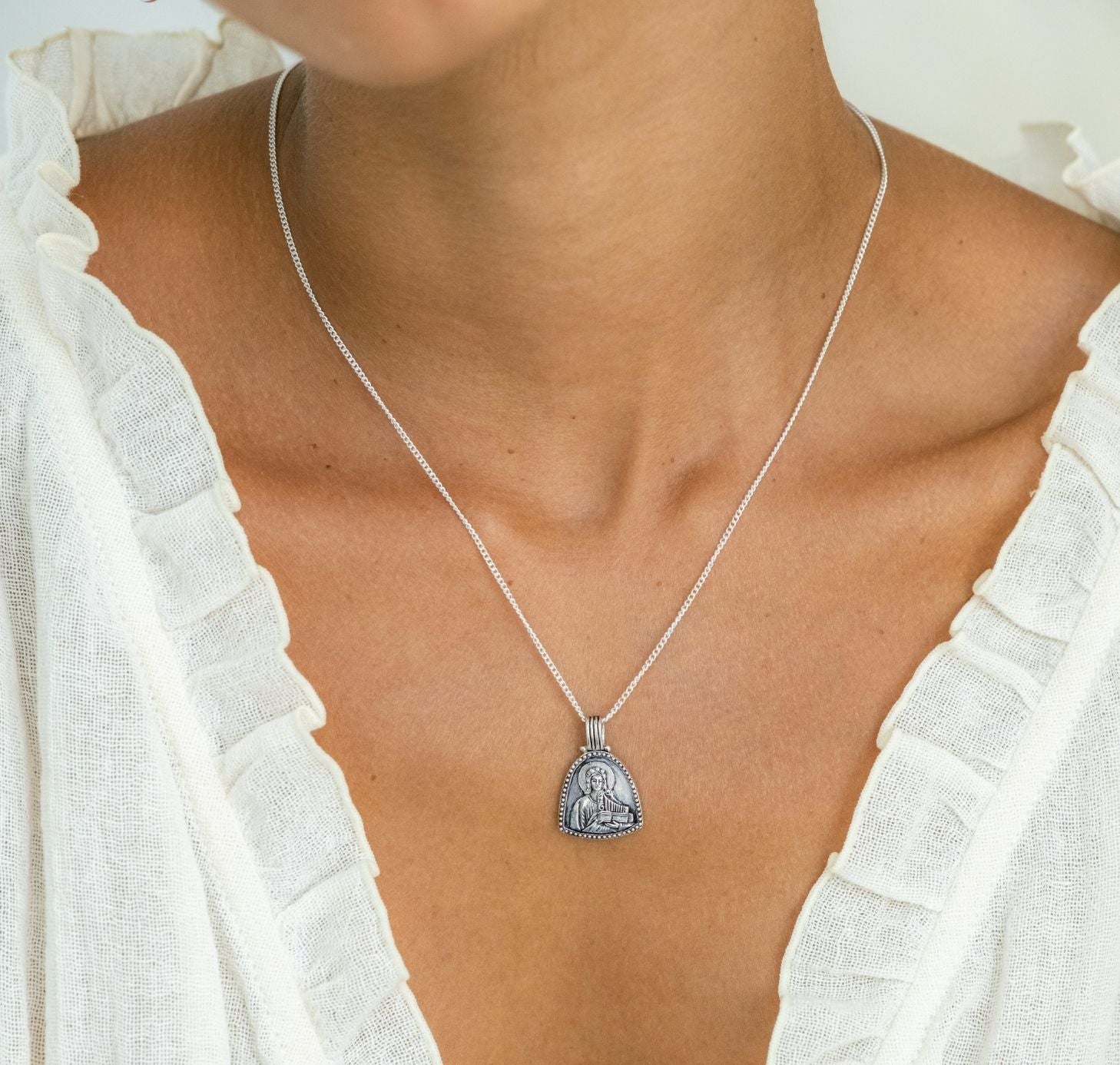 St cecilia pendant silver on a woman close-up