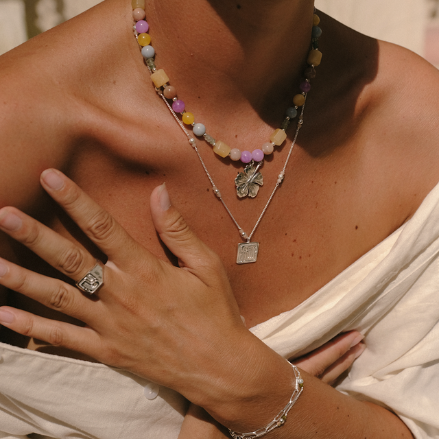 Sunny day scene with a woman styled in silver jewelry