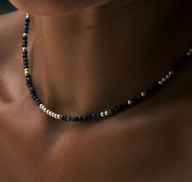 Close-up of a woman styled indigo tide necklace