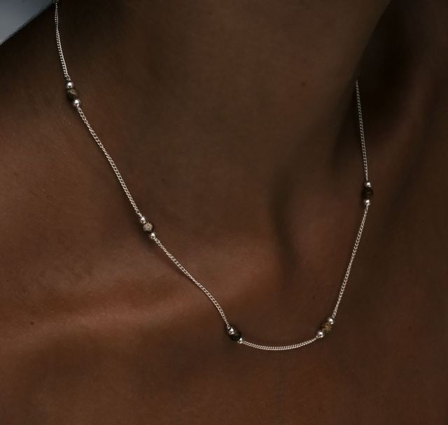 a woman wearing The Sunstone Necklace Silver by Luna and Rose Bali
