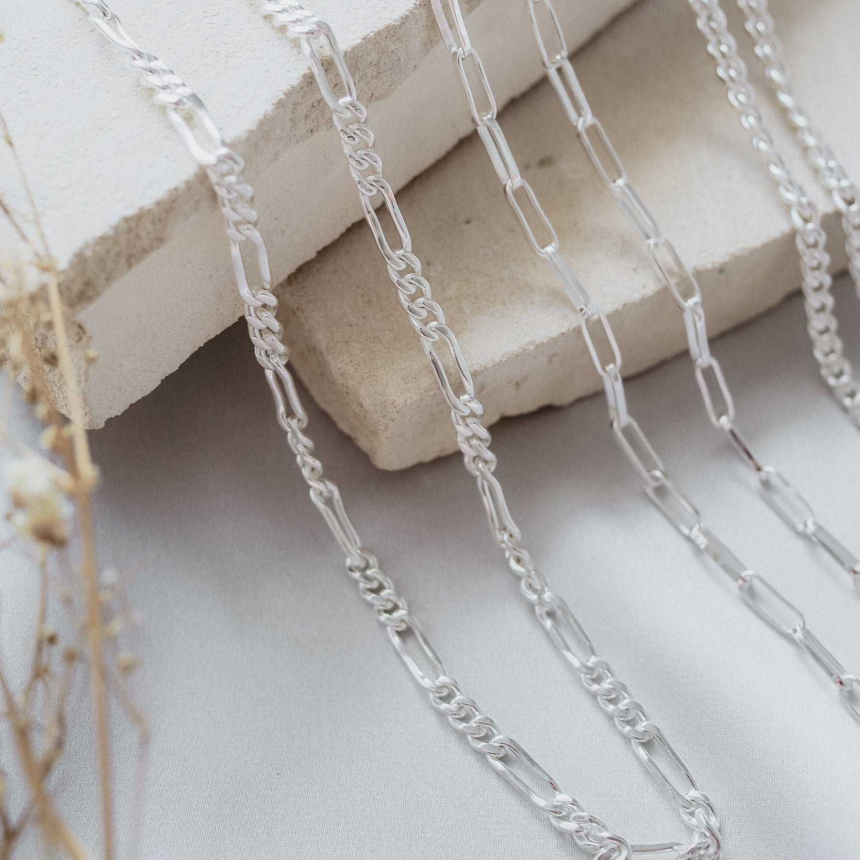 Washington Paper Clip Chain Necklace - Silver displayed on beige stone with others two styles necklaces silver