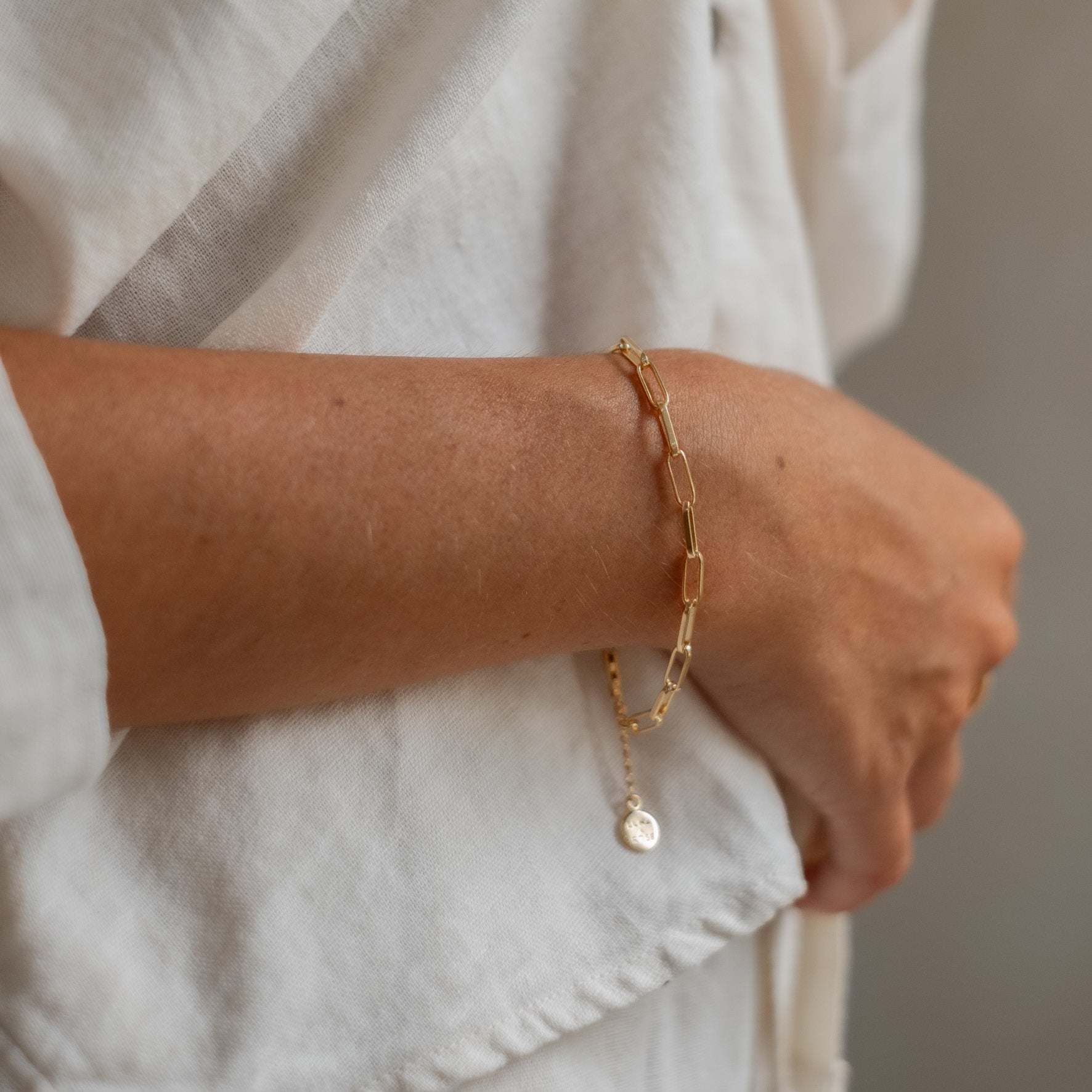 a woman with white shirt wearing Washington Paper Clip Bracelet - Gold