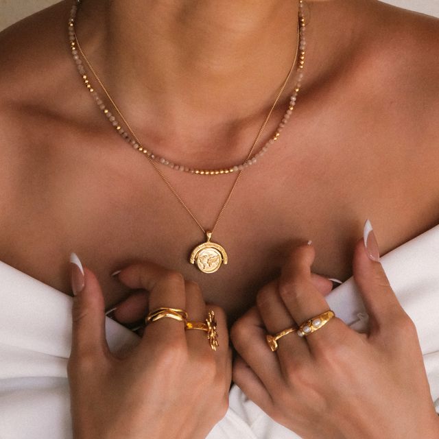 a woman opened her shoulder worn layered necklace