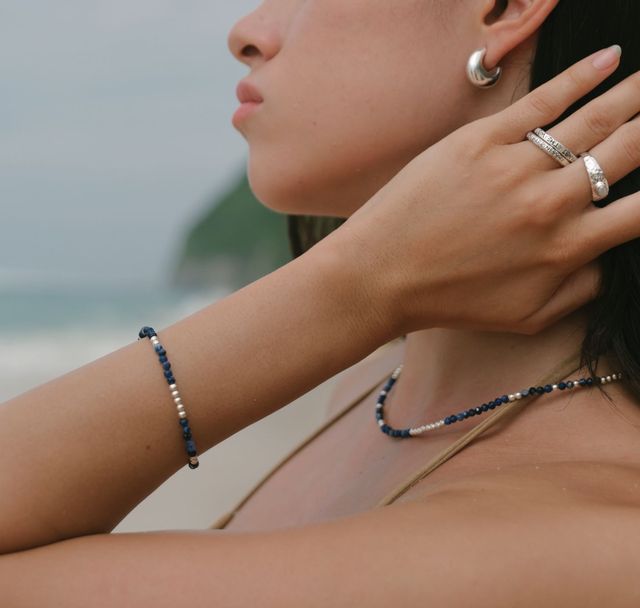 a woman wearing The Indigo Tide necklace and bracelet silver by luna rose