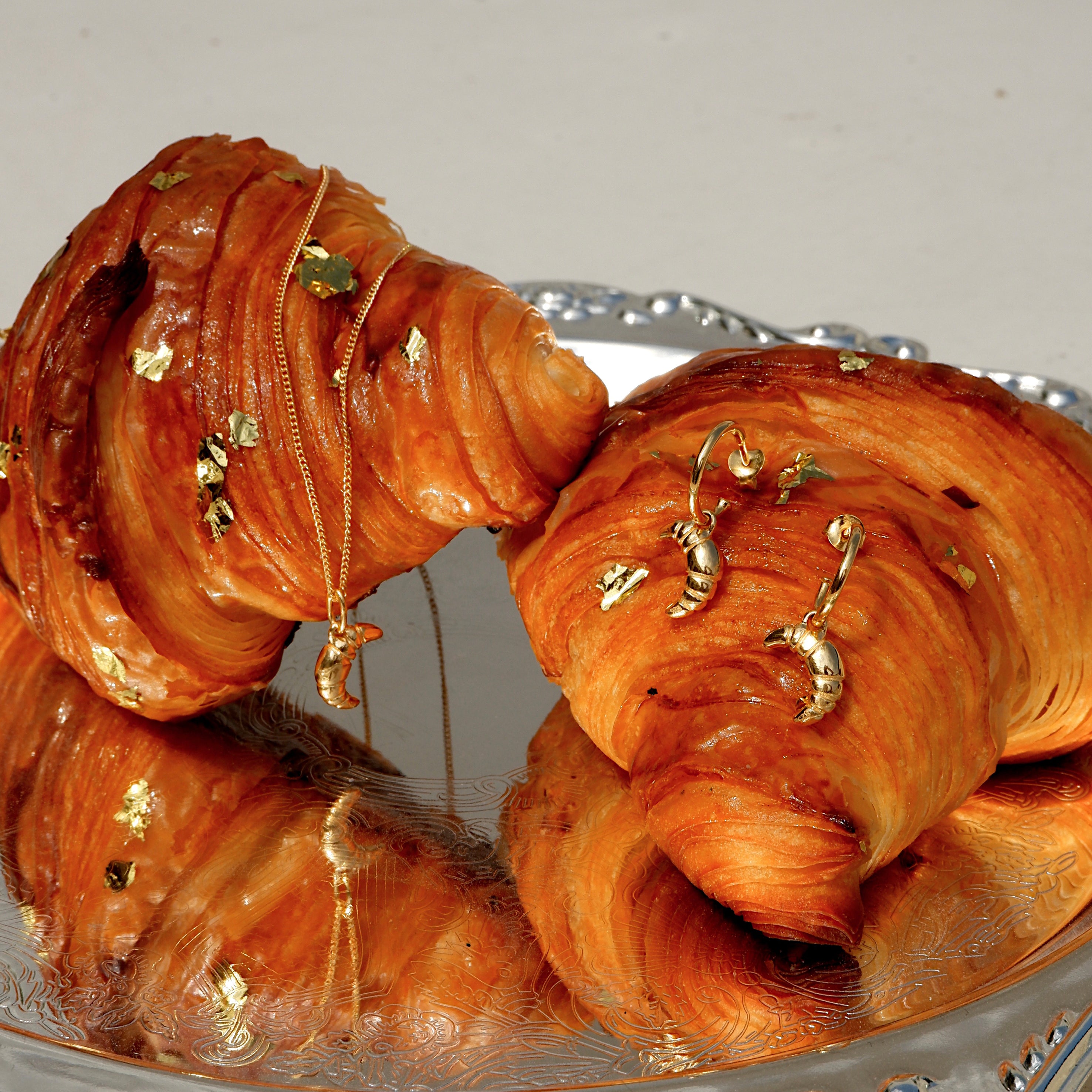 Gold Croissant Earrings from the ACME x Luna & Rose collection, unique croissant-shaped earrings for a playful yet elegant everyday look.