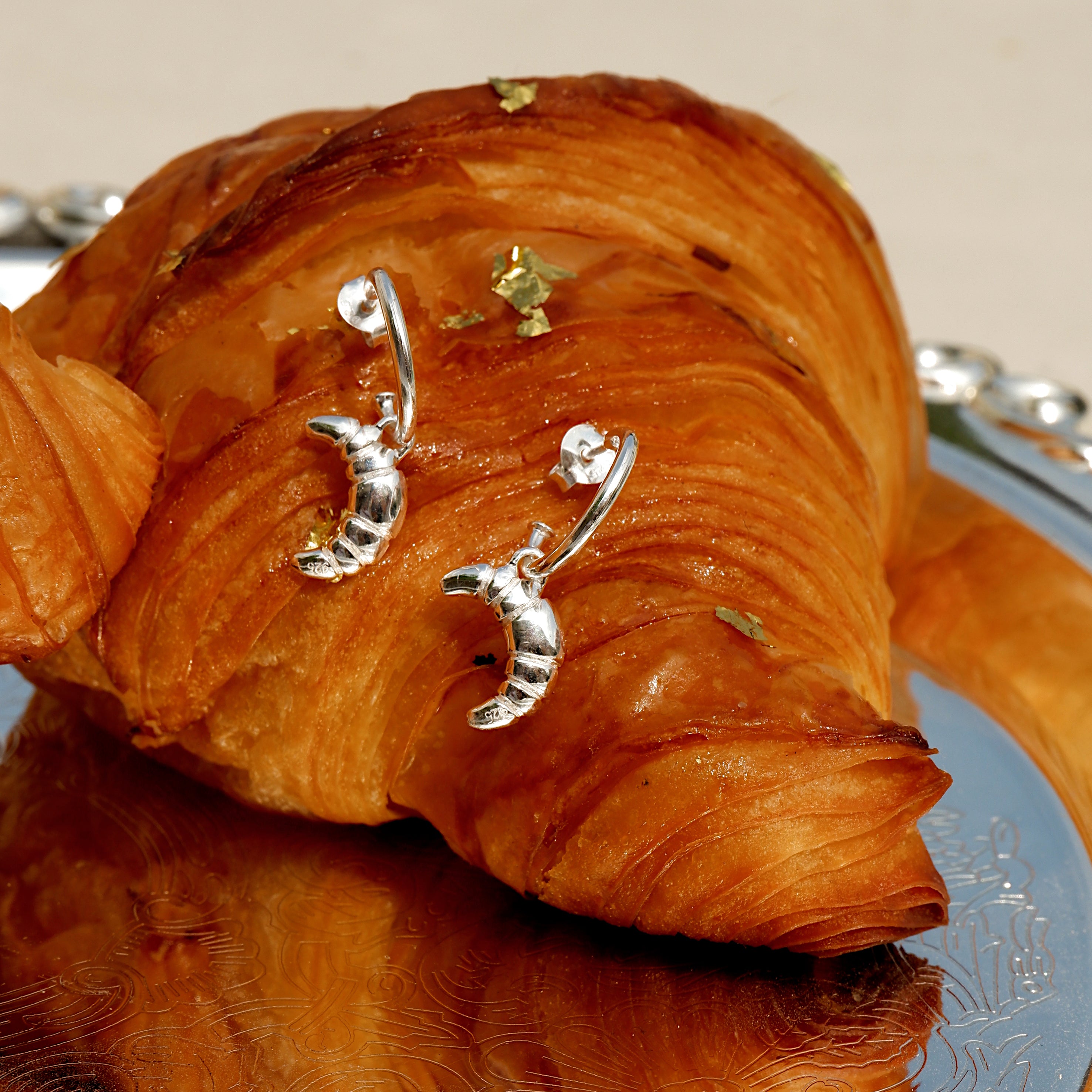 Silver Croissant Earrings from the ACME x Luna & Rose collection, croissant-shaped statement earrings for a fun and timeless style.