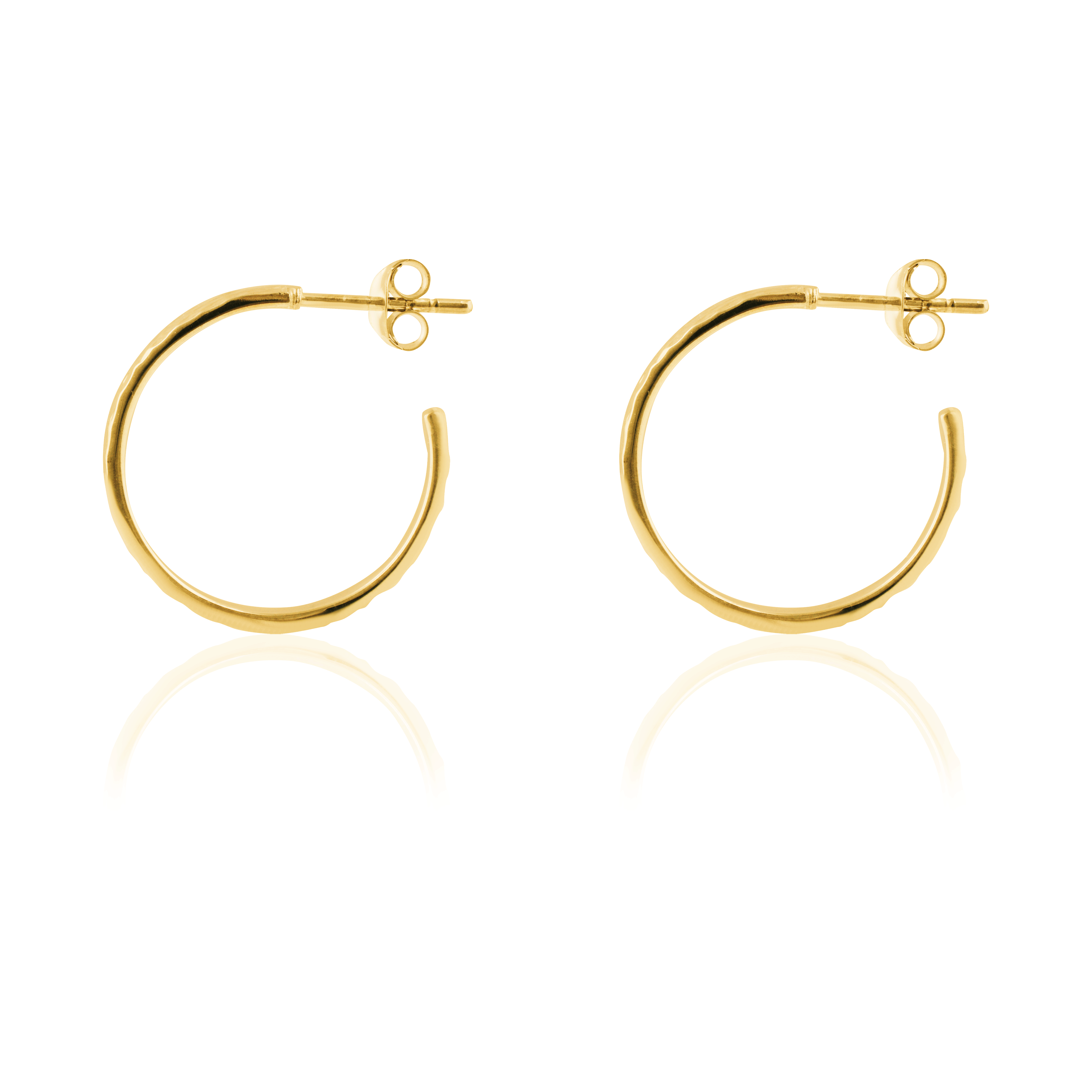 Side view of a pair of hammered gold hoop earrings with post backings on a reflective white background.