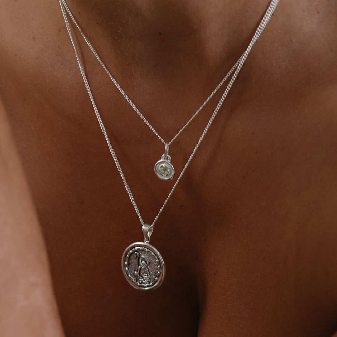 Sterling silver birthstone necklace layered with a delicate silver chain for an elegant everyday look