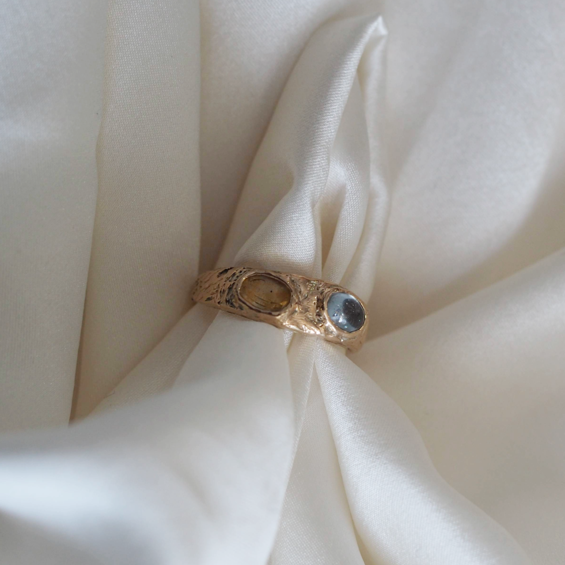 Solid gold Rosie ring with two customizable stones, a refined and personal piece.