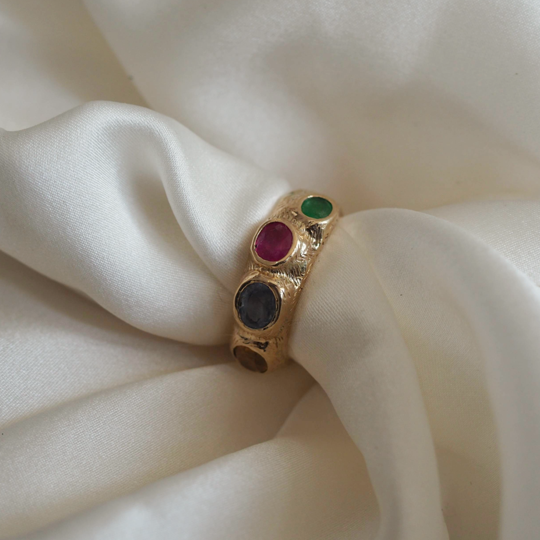 Solid gold Rosie ring with four customizable stones, a symbol of elegance and craftsmanship.