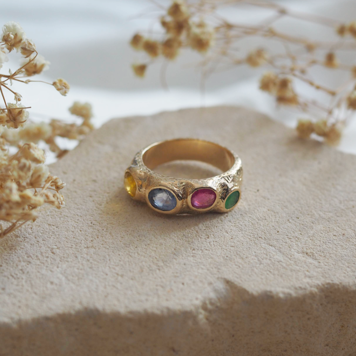 Solid gold Rosie ring with two customizable stones, a refined and personal piece.