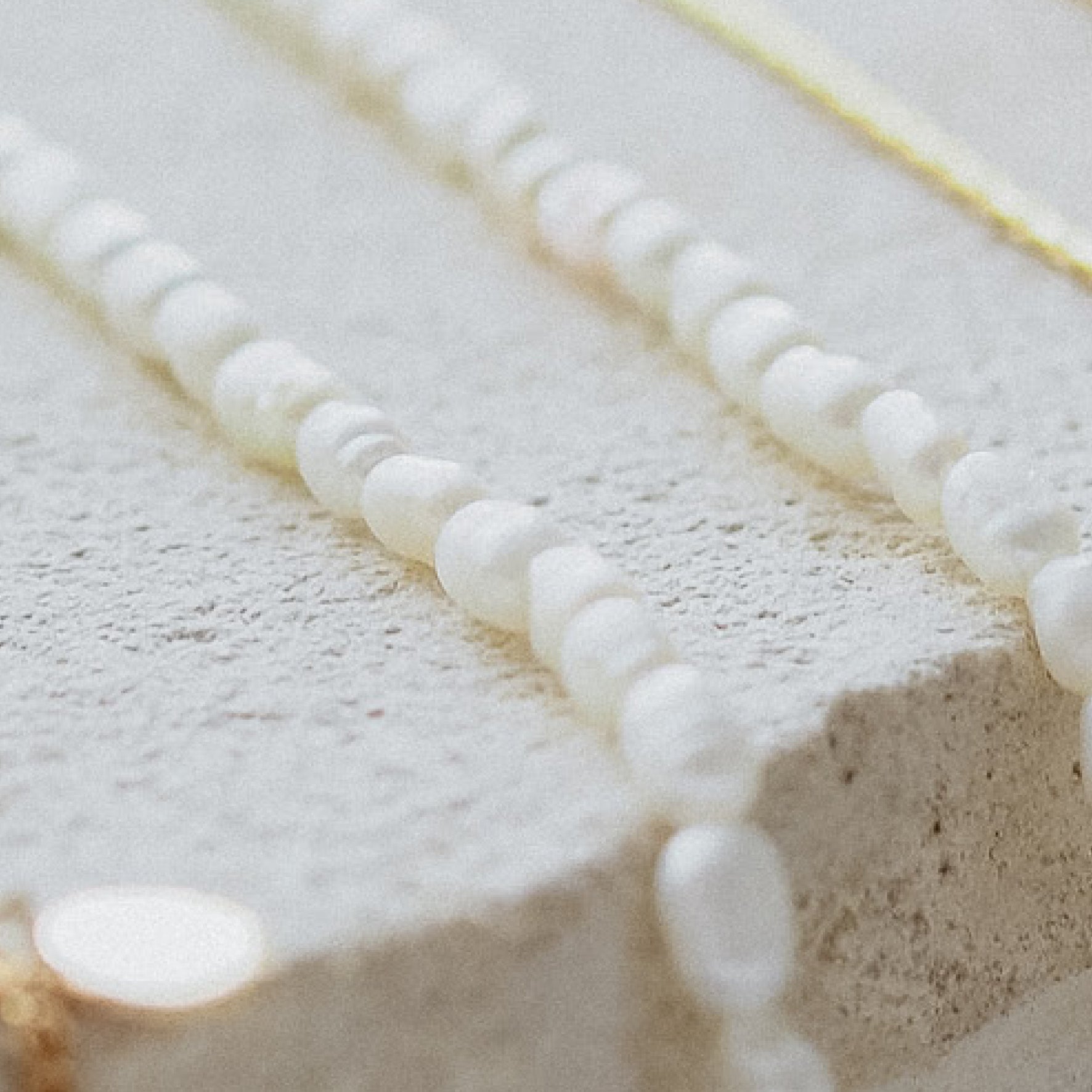 Timeless Mini Pearl Bracelet - Silver flat lay on beige stone