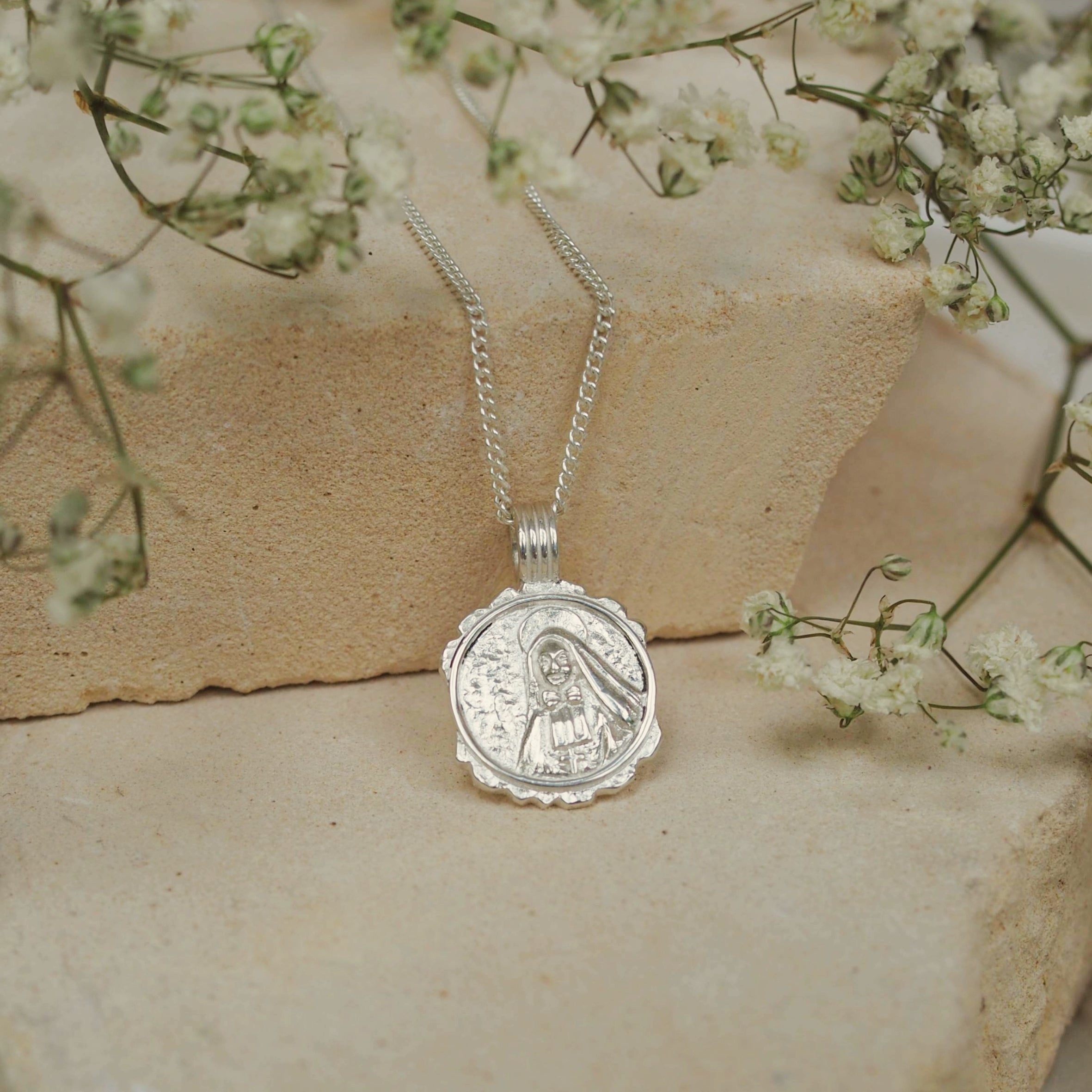 Saint Cabrini displayed on beige stone