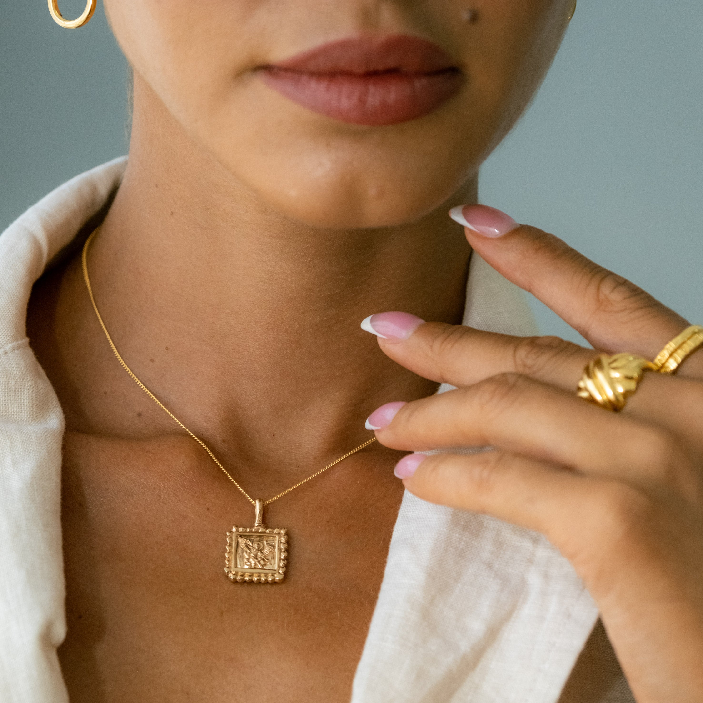 a woman wearing St Michael - Patron Saint of Protection & Overcoming Challenges