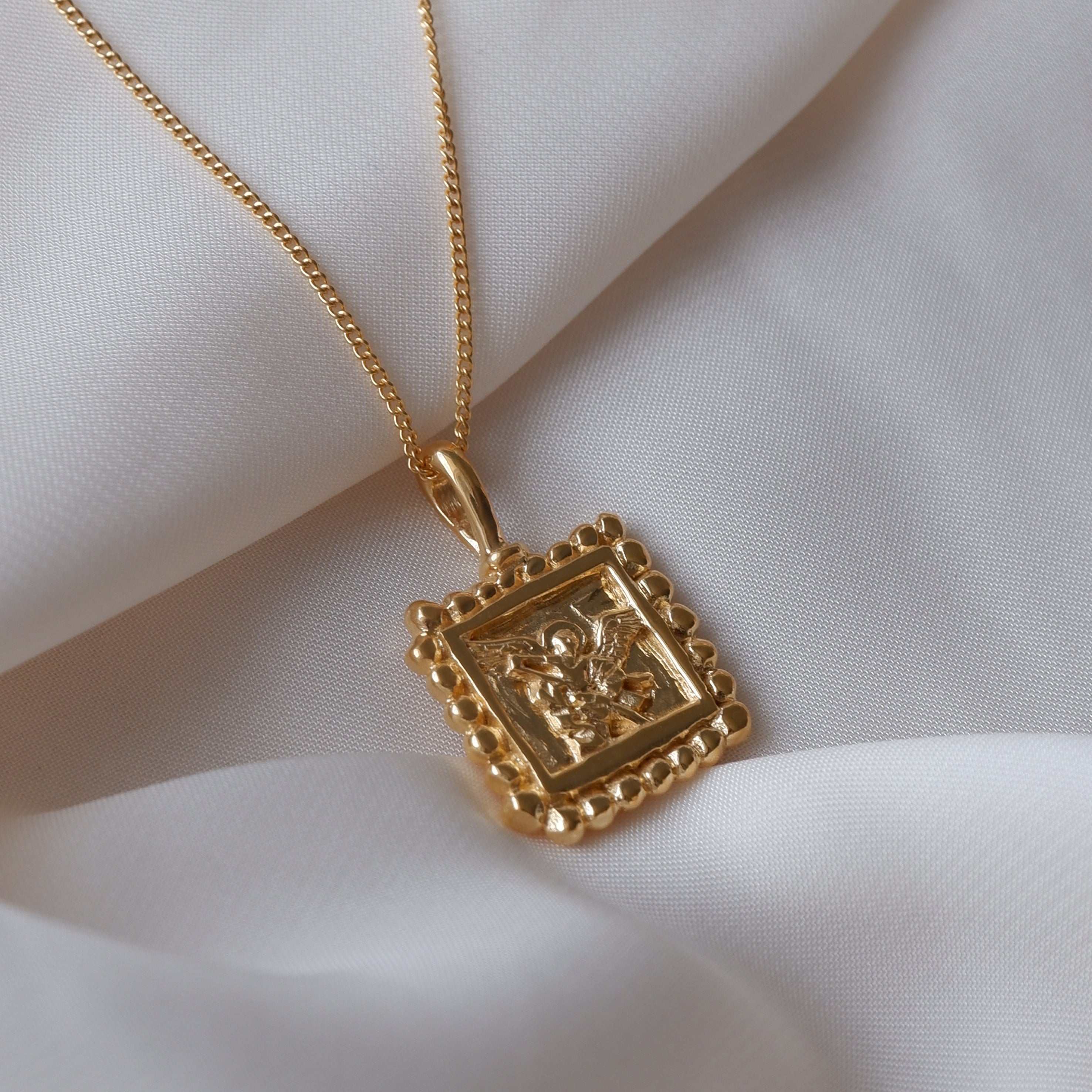 St Michael - Patron Saint of Protection & Overcoming Challenges flat lay in white fabric