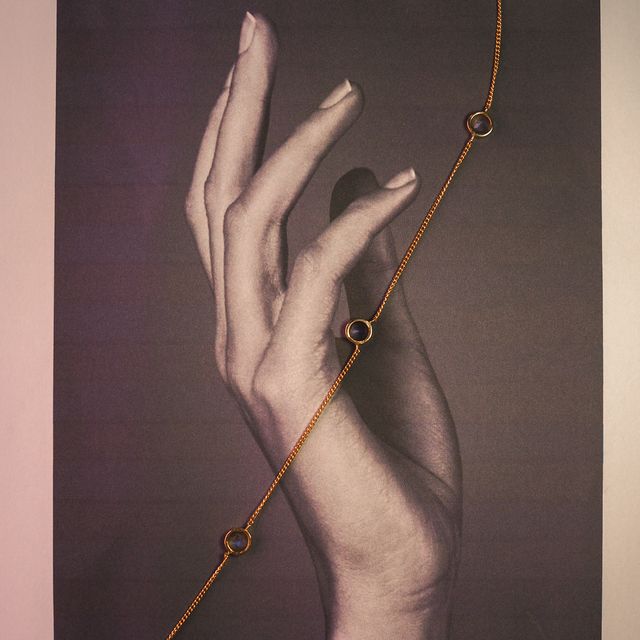 Close-up of a gemstone necklace resting on printed photo paper