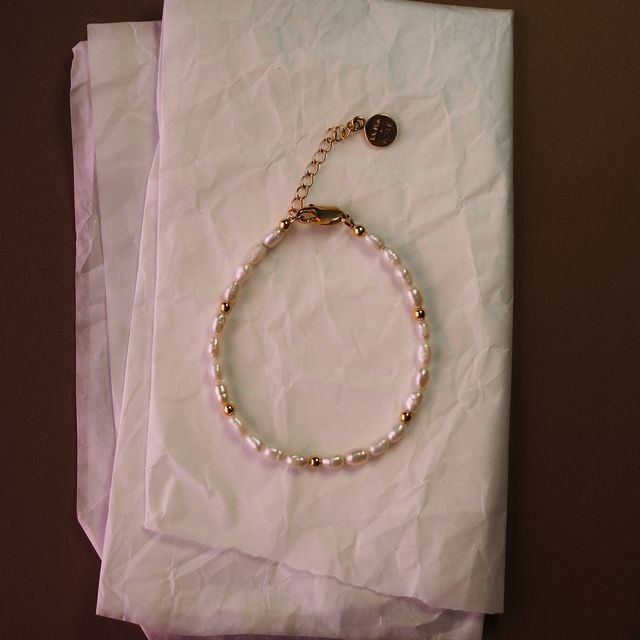 the remi bracelet gold lay on white tissue paper by luna rose