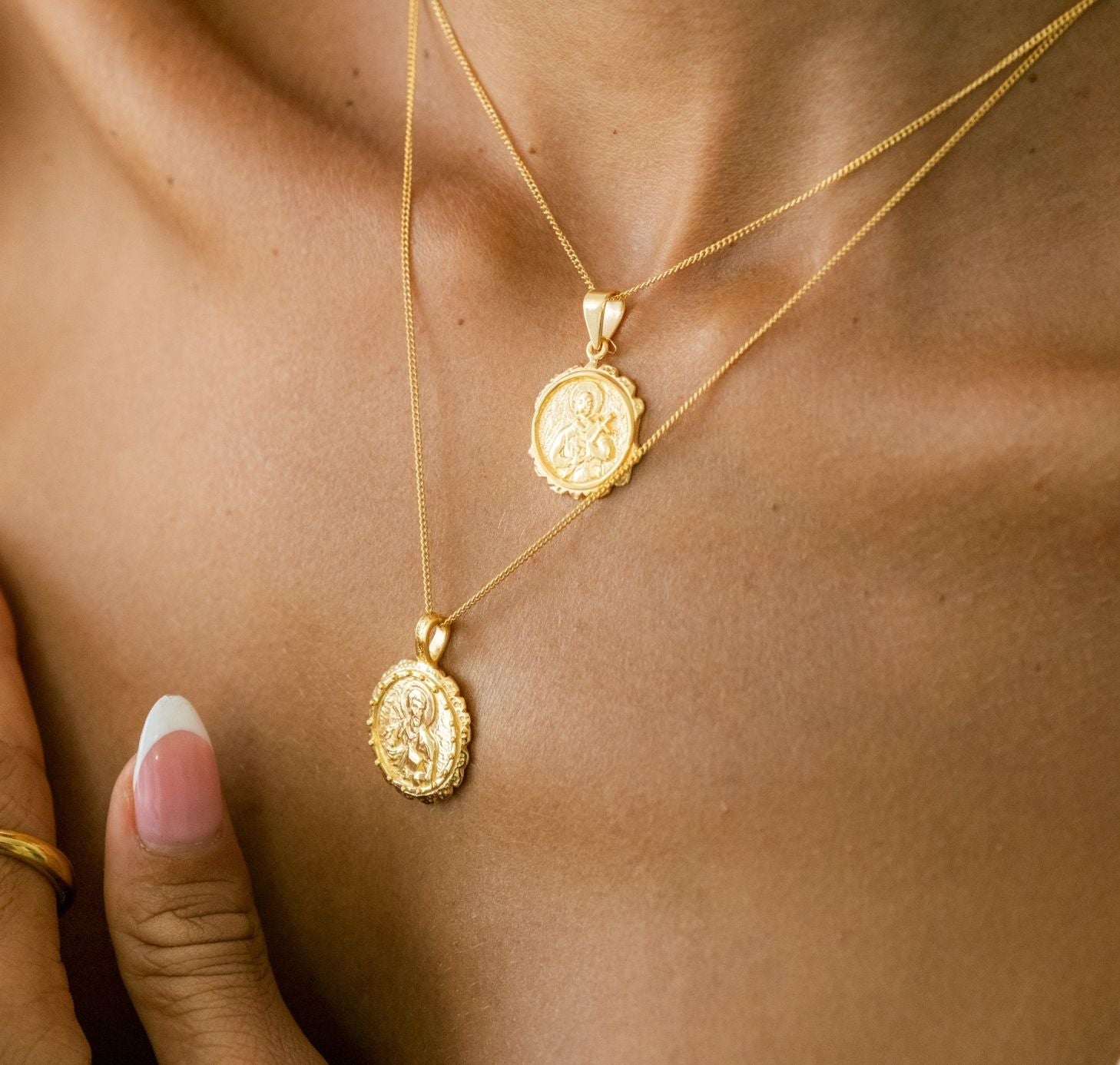 a woman with her two layered necklaces gold
