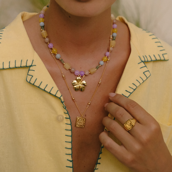 un-kissed look with gold jewelry on a woman
